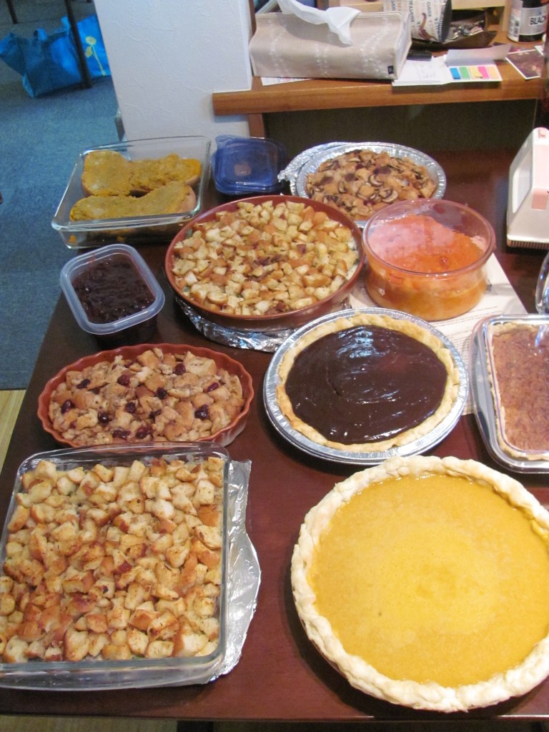 My poor squash that got a bit flattened on the train; vegetarian stuffing, green bean casseroles, cranberry sauce, root vegetable puree, and pies. 