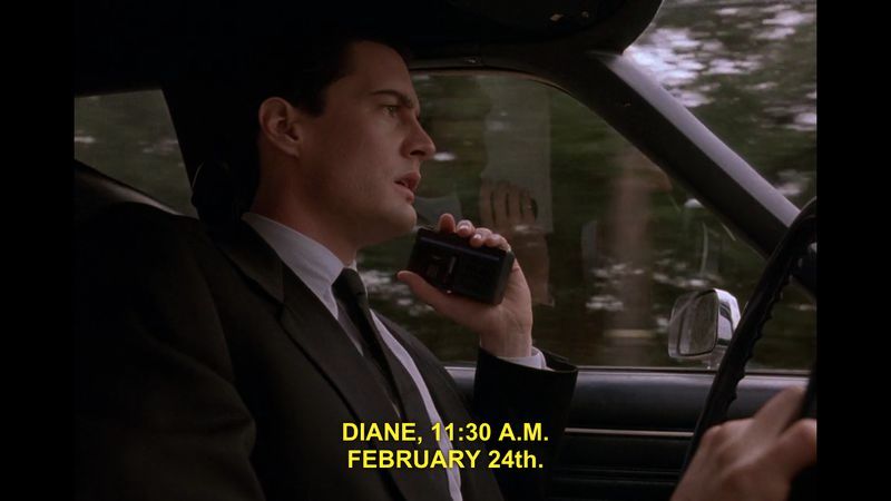 Image: Kyle Maclachlan as Special Agent Dale Cooper in Twin Peaks. He is driving and speaking into a tape recorder. "Diane, 11:30 AM. February 24th."